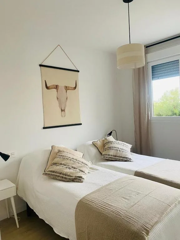 Slaapkamer met twin bedden en raam, Residencia Jardin del Rio